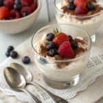 Ricotta dessert is served in glass cups with spoons.