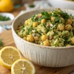 herby lemon mashed chickpea salad in rustic bowl